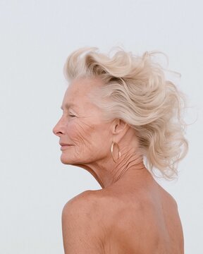 Older adult in side profile with windswept blonde hair