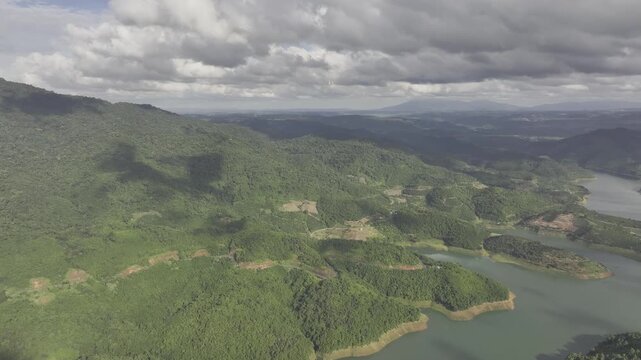 Aerial drone view of Ta Dung Lake surrounded by hundreds of green island hills and mountains in Ta Dung Commune, Lam Dong Province, Vietnam. View from QL 28. D Log mode