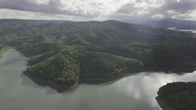 Aerial drone view of Ta Dung Lake surrounded by hundreds of green island hills and mountains in Ta Dung Commune, Lam Dong Province, Vietnam. View from QL 28. D Log mode