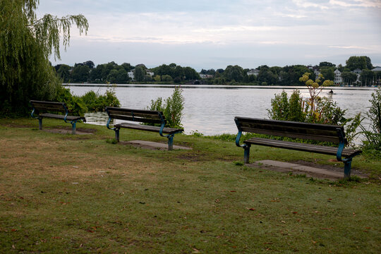 Panoramic view across the Au&szlig;enalster lake under a soft morning sky in Hamburg, Germany.