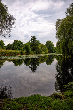 Panoramic view across the Au&szlig;enalster lake under a soft morning sky in Hamburg, Germany.