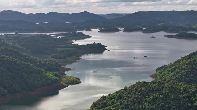 Aerial drone view of Ta Dung Lake surrounded by hundreds of green island hills and mountains in Ta Dung Commune, Lam Dong Province, Vietnam. View from QL 28. D Log mode