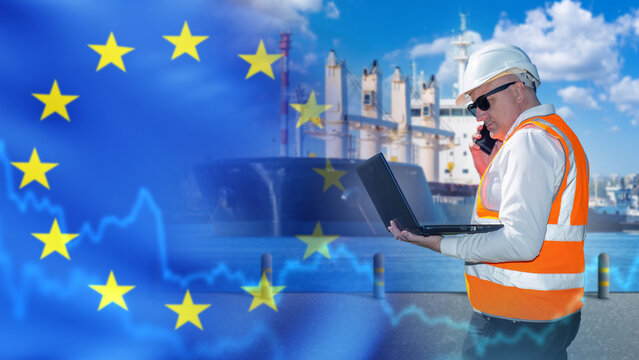 Port logistics operations, engineer monitors maritime fuel terminal and shipping logistics using laptop and phone, with EU flag overlay and port infrastructure.