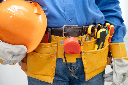 Male builder worker with tool belt pocket at waist.
