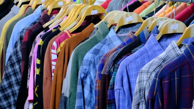 Clothing rack with diverse shirts on hangers