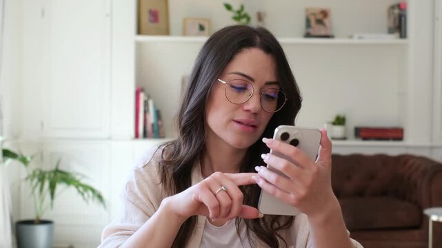 A pensive young woman with glasses uses her smartphone, then thoughtfully removes them and appears lost in deep reflection or contemplating a new idea.