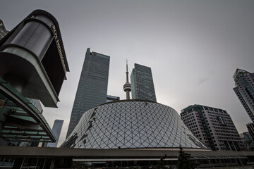Fototapeta premium TORONTO, CANADA - DECEMBER 31, 2016: CN Tower rises among downtown Toronto skyscrapers showing Canada well known communications and observation tower within the city's modern skyline.