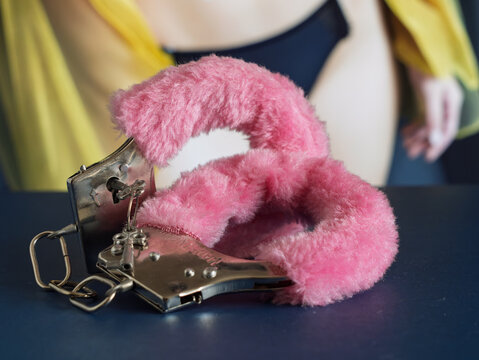 Pink Handcuffs Symbolizing Freedom and Playfulness in Relationships