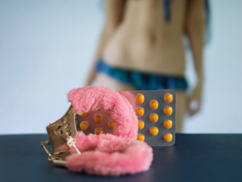 Colorful Pills and Fluffy Restraints on Table