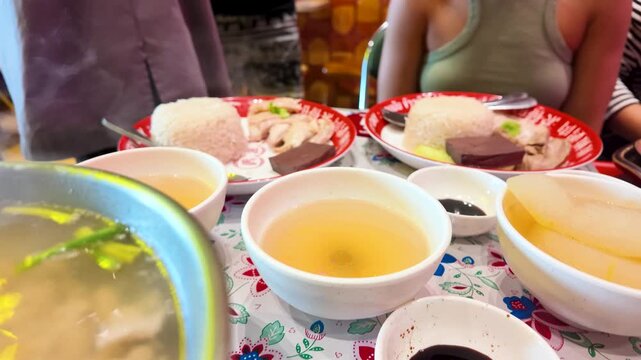 Steaming Hot Pot and Thai Chicken Rice on Table in Bangkok