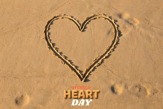 Heart shape drawn in the sand on a beach for World Heart Day celebration
