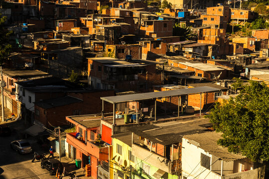 An aerial detailed view of the crowded Morro do Piolho favela community (also known as Sonia Ribeiro) composed of brick houses next to the Roberto Marinho Avenue 