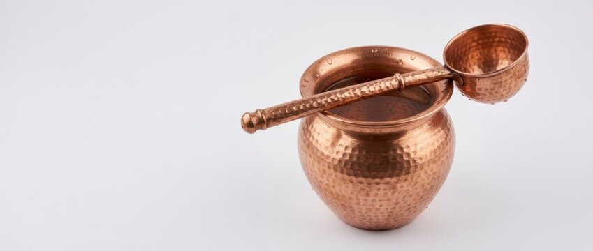 Traditional copper pot with ladle for ceremonial bath and ritual cleansing