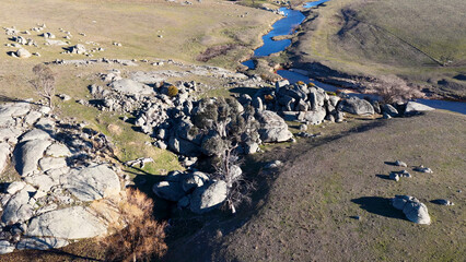 Fototapeta premium Aerial View of Granite Boulders and Winding Creek in Uralla Countryside