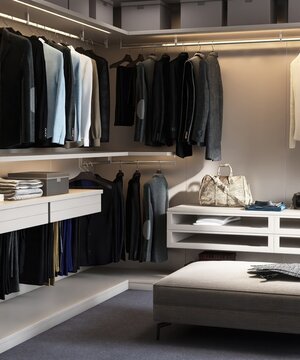 Luxury, elegant built in walk in closet with led light in corner for menswear and ottoman in sunlight on gray carpet floor for interior design decoration, architecture, product background 3D