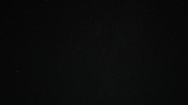Timelapse video of stars moving across a dark night sky, revealing the subtle motion of the celestial landscape over time. A peaceful astronomy scene ideal for themes of space, stargazing, nighttime,