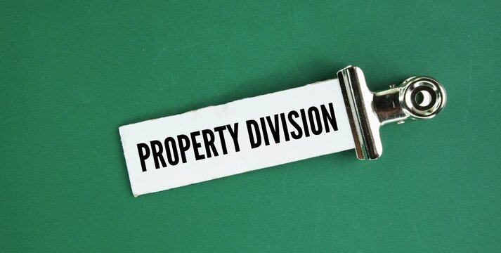 Paper with the word property division. the legal process of splitting a couple's assets and debts when a marriage or relationship ends.