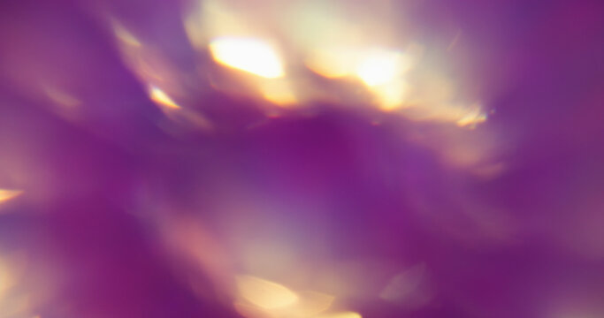 Blur shiny background. Colorful glow. Purple yellow blue radiant flash optical texture rainbow kaleidoscope on art bokeh light abstraction.