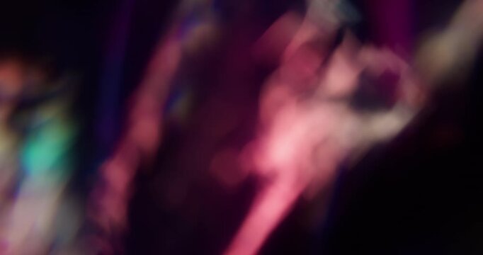 Bokeh art. Abstract neon light. Purple pink blue colorful radiant texture optical visual flash on illuminated dark black background.