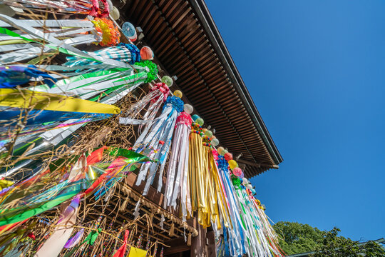 Low angle view of Miyajidake Shrine wooden gate decorated with colorful tanabata streamers in Fukutsu, Fukuoka, Japan