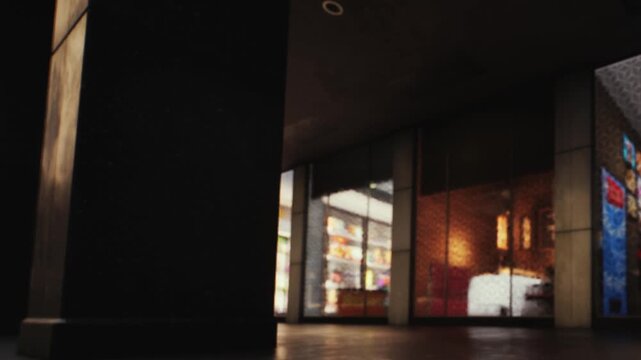 A view of a storefront in a city taken during the evening. Lights from inside the store illuminate the space. Dark surroundings highlight the bright displays. People may be walking nearby.