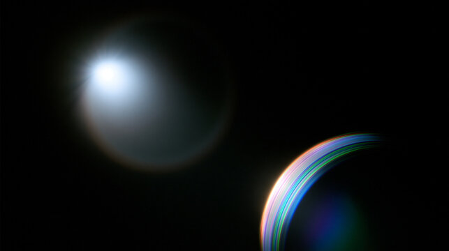 Bright optical lens flare glowing in a dark environment with vibrant chromatic aberration rings. Perfect background asset for futuristic sci-fi design and video overlays.