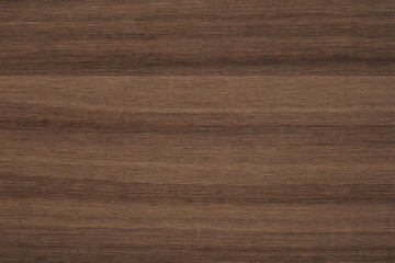 Naklejka premium Natural walnut wood texture with rich deep brown tones, elegant flowing grain, and subtle organic variation, creating a refined premium surface for furniture, cabinetry, flooring, interiors, and archi