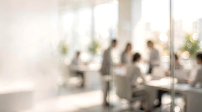 Softly blurred modern white corporate office interior with a diverse group of business professionals working naturally in the background. Bright open-plan workspace featuring clean white architecture.