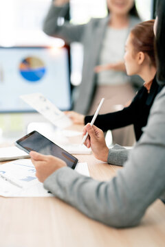 Close Up Business Professional Holding Digital Tablet and Stylus Pen during Team Meeting