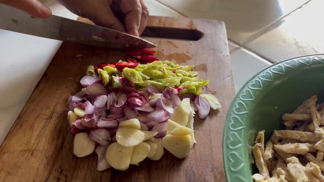 Sliced red onions, chili, and garlic ready for cooking