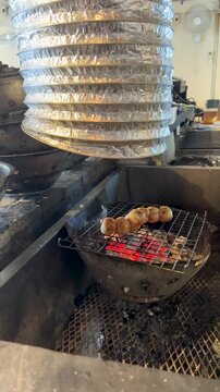 Grilling Meat Skewers on Charcoal Barbecue in Bangkok