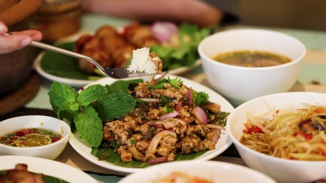 Traditional Thai Isan Meal with Spicy Minced Pork and Papaya Salad