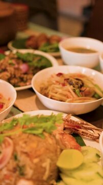 Traditional Thai Isan Food Spread with Papaya Salad and Seafood