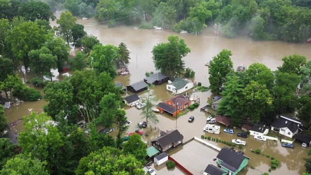 Flooded Homes and Vehicles along overflowing river in American Town