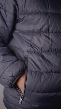 Puffer jacket with zipper pocket for winter wear.