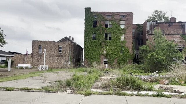 Panning shot of abandoned brick buildings and demolition rubble in Cairo, Illinois.