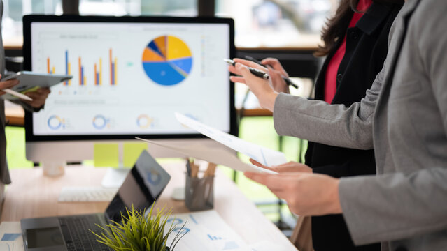 Business Presentation Hands Pointing At Financial Chart On Monitor Close Up