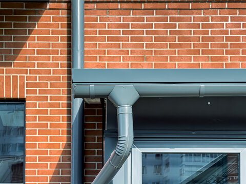 newly renovated old industrial building facade with rain gutter system.