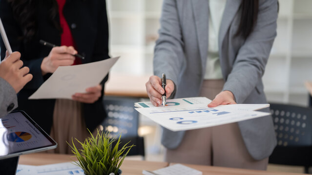 Business Meeting Hands Pointing Pen At Paperwork Document Close Up