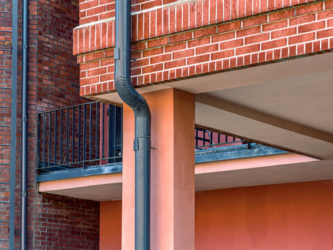newly renovated old industrial building with installed new metal drainpipe.