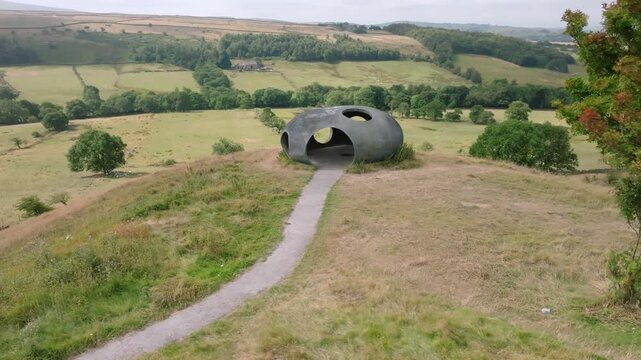 The Atom Panopticon, Wycoller, Pendle, Lancashire, UK. Reveal From Tree Showing Hillside Aspect Of The Artwork And Wider Valley