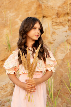 Girl Holding Pampas Grass While Looking Aside Outdoors