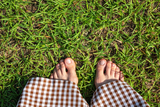 Bare Feet on Green Grass Connecting with Nature in Summer