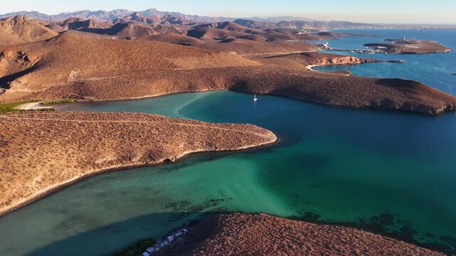 Aerial view of turquoise shallow water bays surrounded by desert hills in Balandra La Paz Mexico