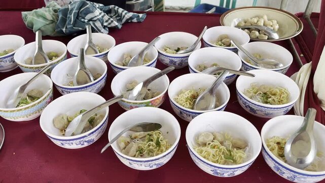 Rows of traditional Indonesian meatball soup bowls ready to serve