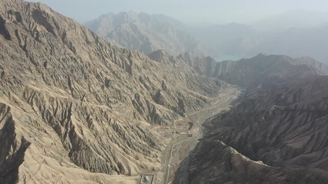 Aerial view of the winding Tasha Ancient Road along the river valley in Taxkorgan, Xinjiang, China