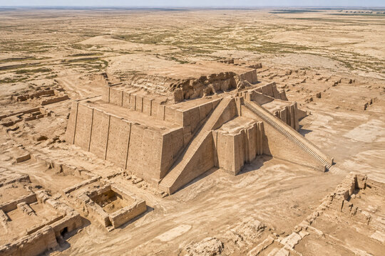 Aerial view of ancient Mesopotamian ziggurat ruins under harsh sunlight.