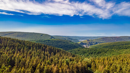 Fototapeta premium Aerial drone view of Ardennes mountains nature landscape from above, hills and green forest on summer