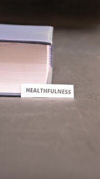 Healthfulness Word on Paper Between Book Pages Wellness Concept Footage