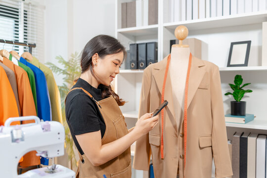 Fashion designer inspecting garment quality, measuring blazer fit and recording design details in a professional fashion studio. Apparel development, clothing quality control and textile craftsmanship